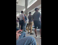 Group of dads in front of airport window watching plane 