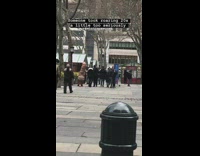 man walking in dinosaur outfit street