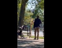 Man sprays water to birds at park