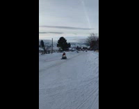 Guy falls off snowmobile