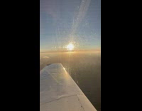 Person pilot a flying plane show sunset