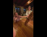 Jenga tower falls over on dinner table 