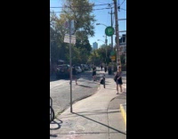 Man black top tiktok dance at street