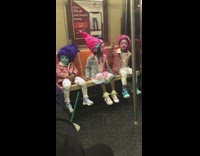Three little girls dress up as the Smurfs on subway train