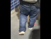 Man walks fast and dog on top of his head at subway 