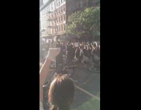 Peaceful protest people kneel arm raised sunset