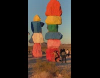 Woman cowgirl costume colored rocks photo shoot