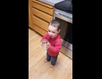 Boy drinks water coughs then pats back