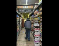 Guy  goes grocery shopping with red bird