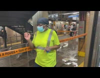 Water leaking next to subway stairs orange tape