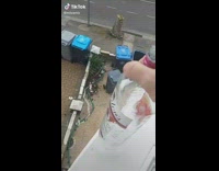 Guy tries to throw empty alcohol bottle into trash but misses