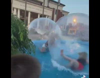 2 friends keep falling inside water balls 