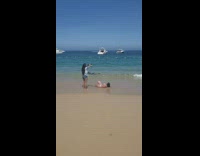 Waves hit girl lay on sand boat