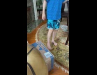 Little boy gets inside cardboard car and then fall sideways