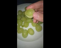 Green grape has smaller grape inside it 