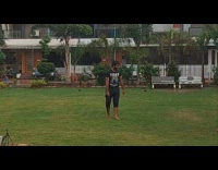Friends play soccer outside in rain 
