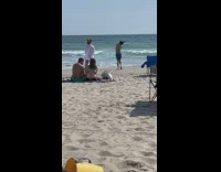 Man dramatic dance beach shore two people watches