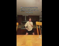 Girl dancing in kitchen table sprayed to beat of music