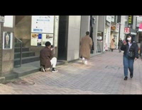 Guy walks down sidewalk for photo