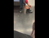 Person on subway picks at toenail