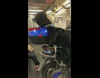 Man sleeping on motorcycle blue 