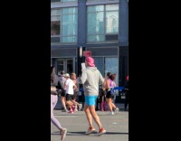 Man holds up sign about the marathon