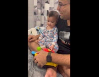 Kid imitates cow noise from his toy