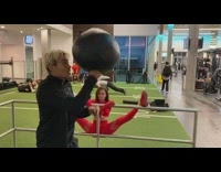 Guy black outfit punches weighted black ball up