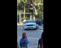 Car stuck on concrete island on road