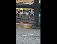 Group of frat guys dressed in preppy clothing walk down the street in a group