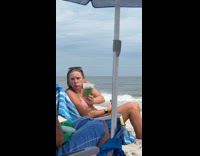 Woman eating pickles at beach pretends to be grinch