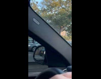 Homeless man along the road pulls traffic cones