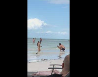 Woman grey bikini kneel pose beach bird