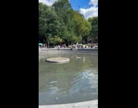 Man lay down in park water fountain