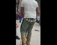 Man on Sidewalk Wears Pet Snake around Neck 