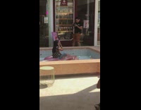 Girl brings props to empty fountain 