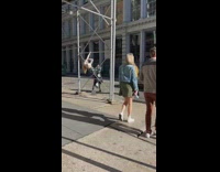 Woman white top poses at the scaffolding