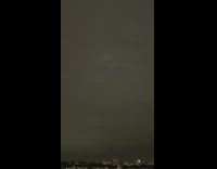 Lights float around clouds in the sky at night