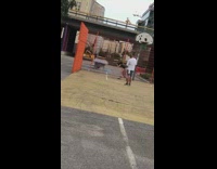 Woman hang orange fence twerk music video