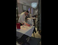 Waiter prepare food for the skeleton on the table 