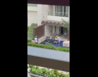 Guy yellow cap sit chair pool cigarette