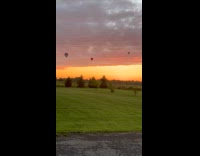 Hot air balloons at sunset sky descends 