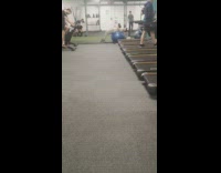 Guy does ab crunches while holding a kettlebell and balancing on a medicine ball