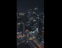 Person sit on ledge tall building Dubai