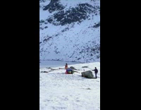 Woman orange dress DJ set snow mountain