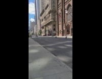 Two girls sit middle of street buildings