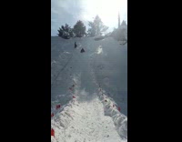 Guy black jacket slides down snow slide