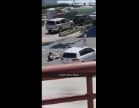 Guy cowboy hat parking lot red building