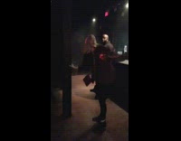 man stares at weird blonde woman dancing