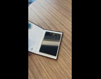 Man opening book with mirror